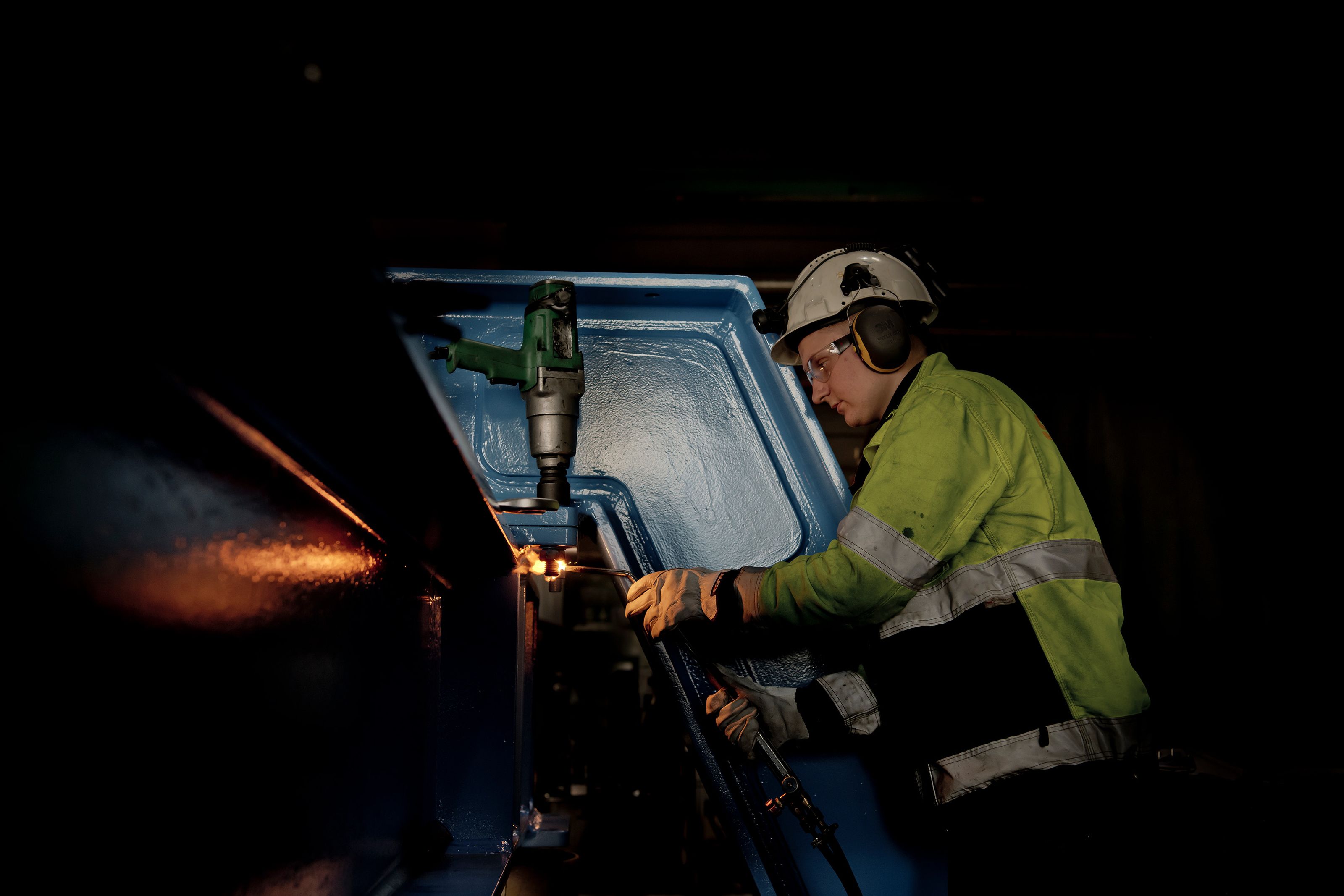 Employee working with welding torch