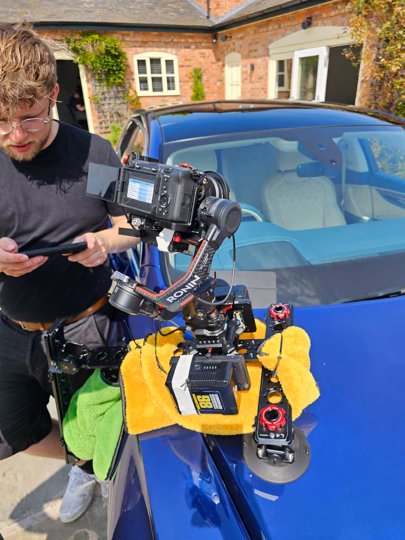 Cameraman recording outdoors.