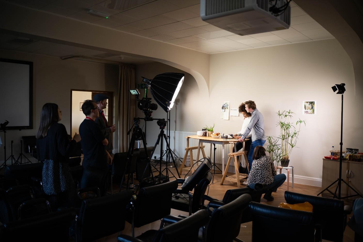 Behind-the-scenes view of a healthcare video production setup with lighting and camera equipment.