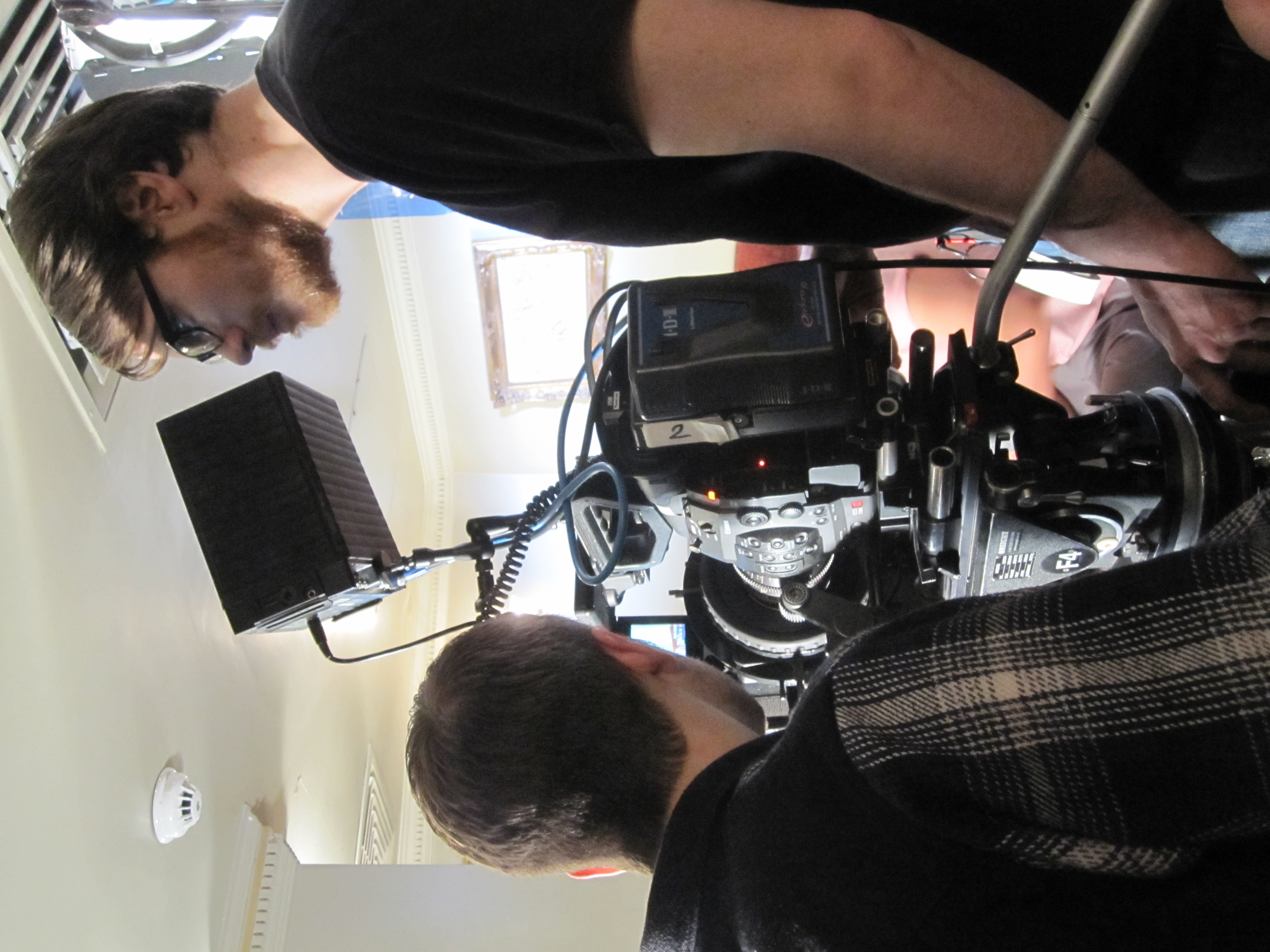 Cameramen adjusting equipment during a shoot.