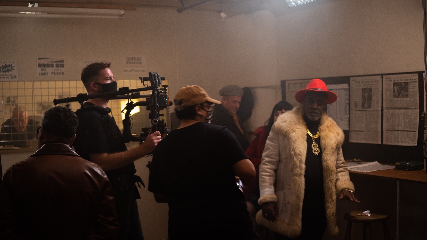 Video production team filming a scene on set.