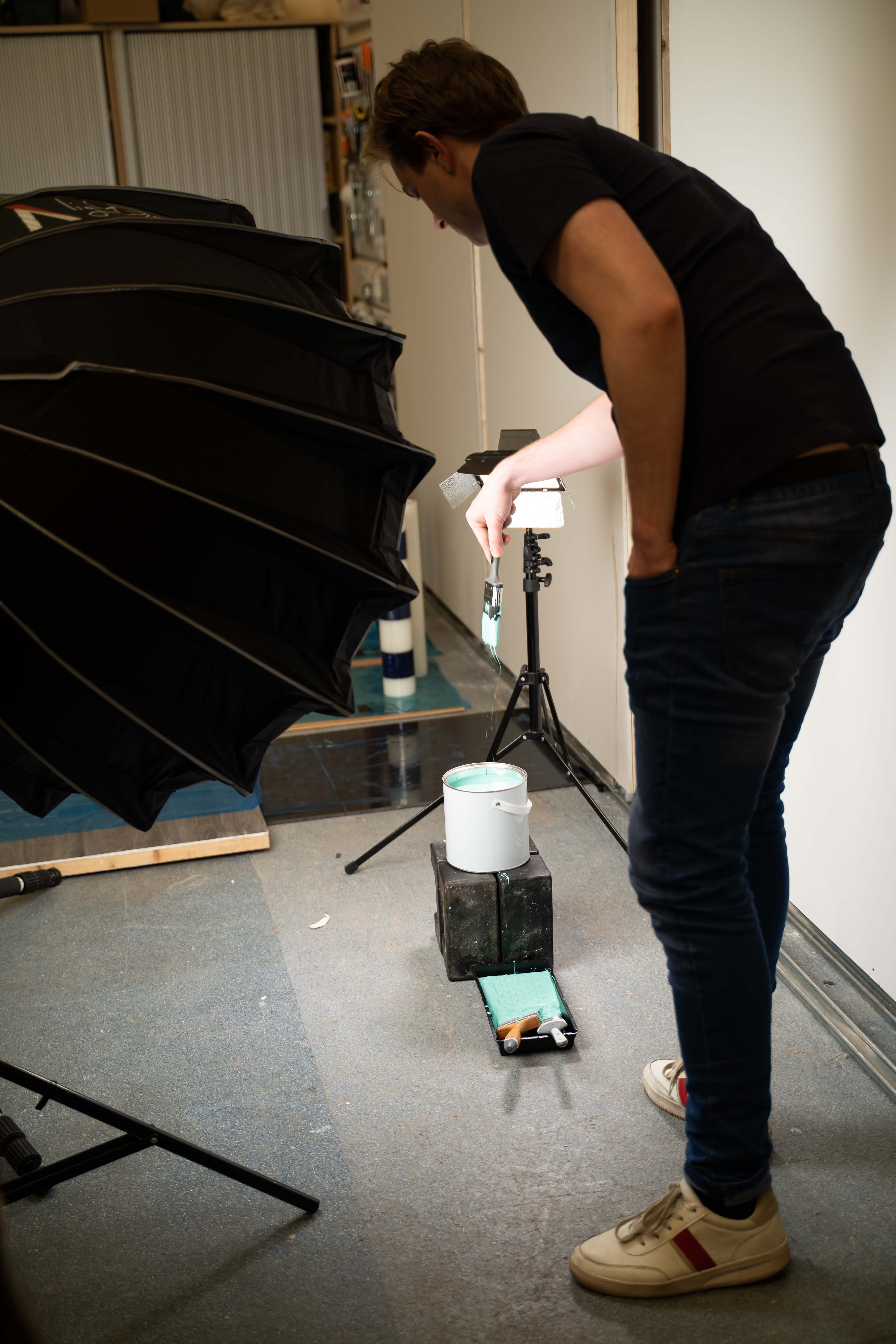 Person adjusting studio light equipment.