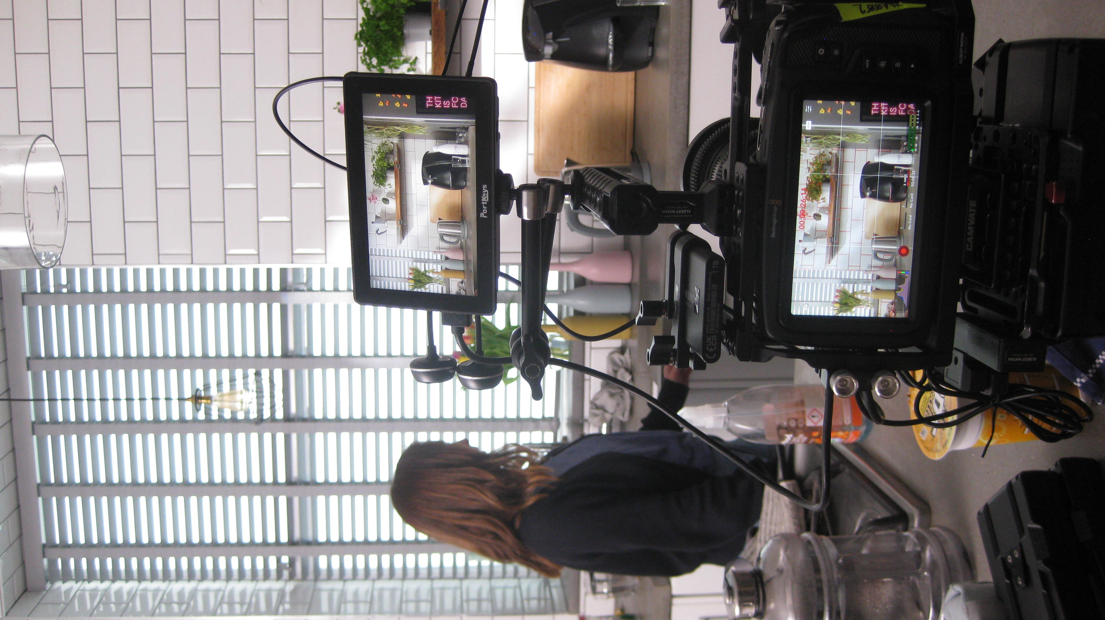 Woman standing beside a video camera setup