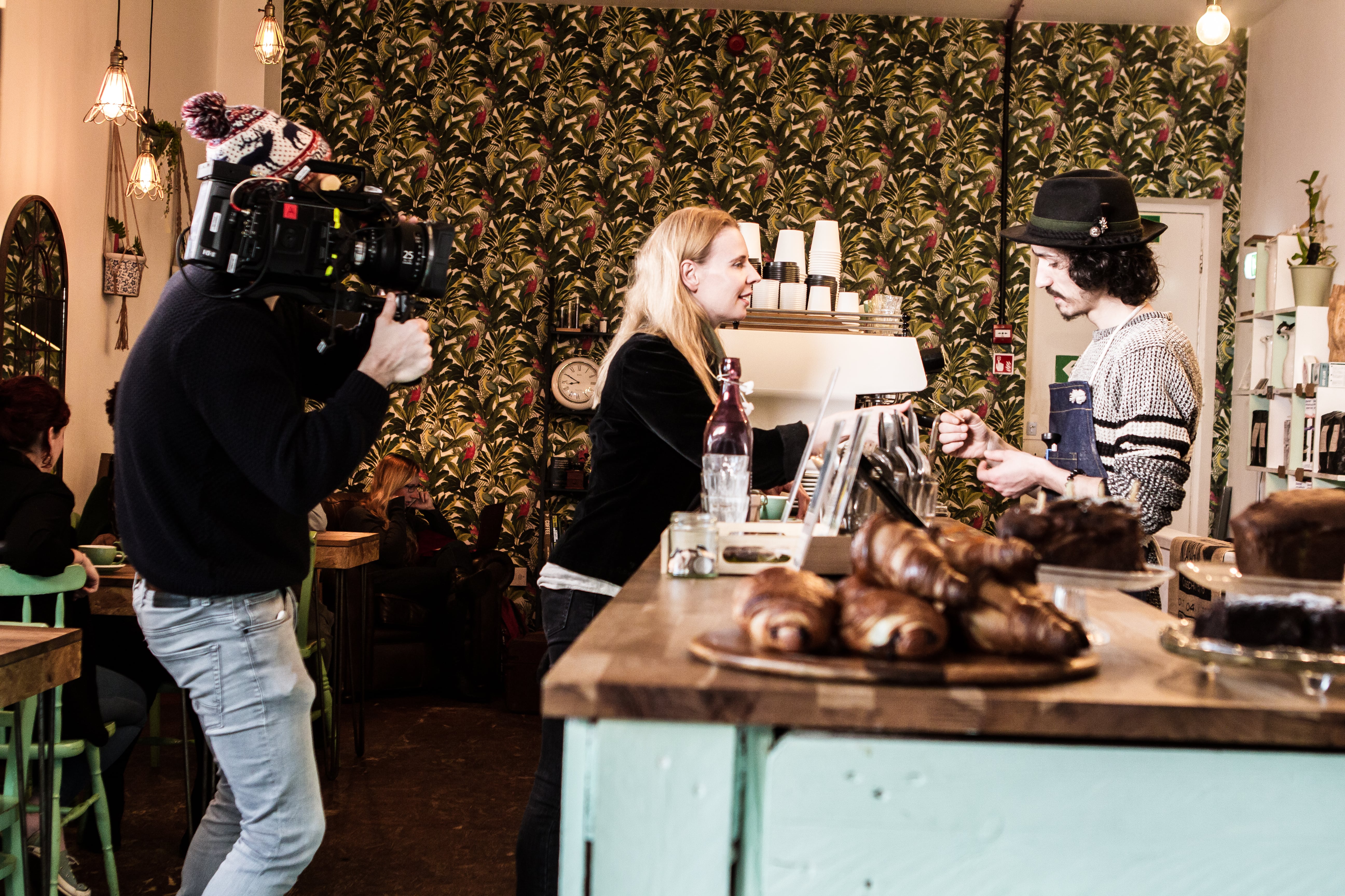 Videographer shooting in a café setting