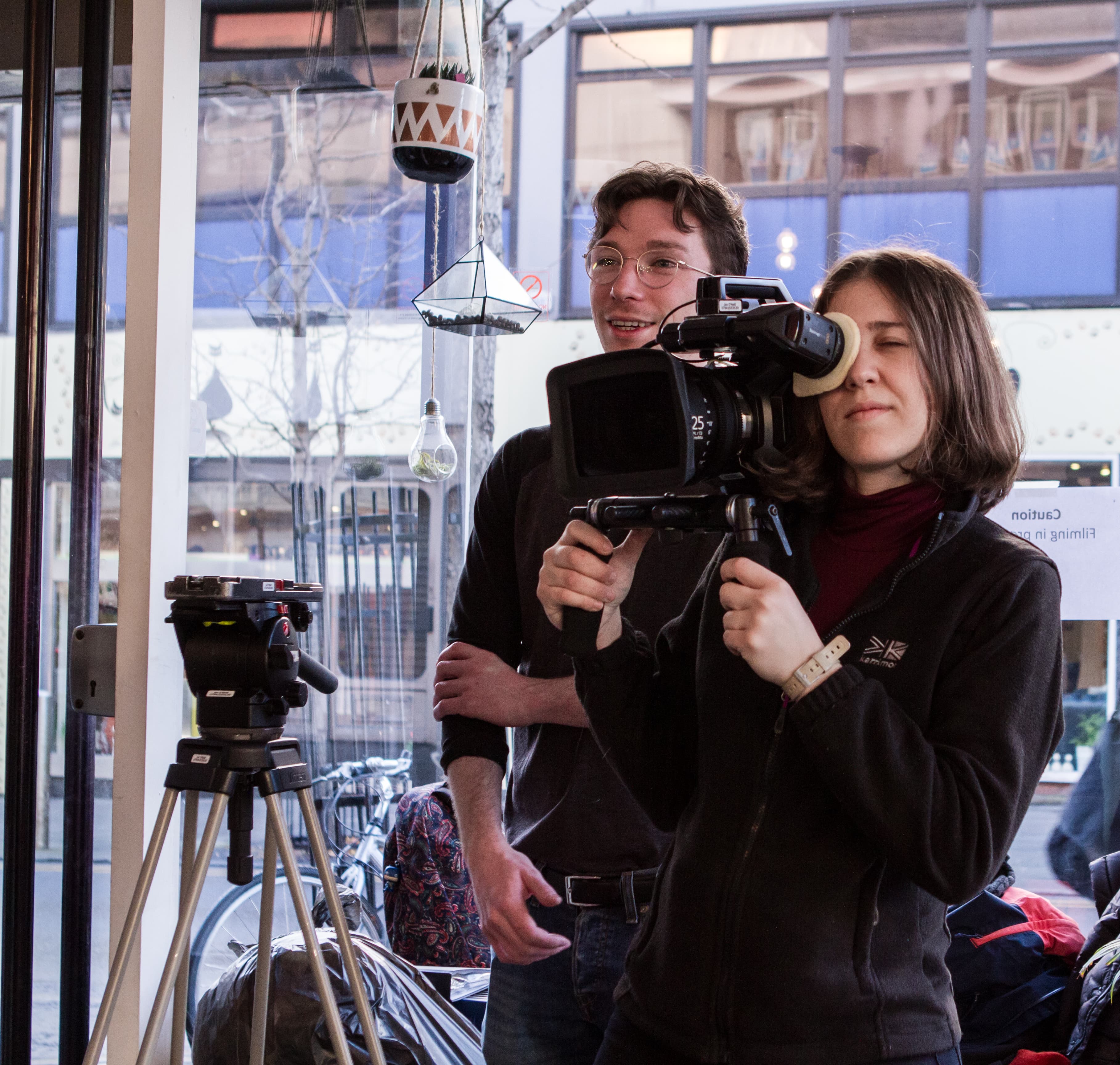 Video crew recording with camera indoors