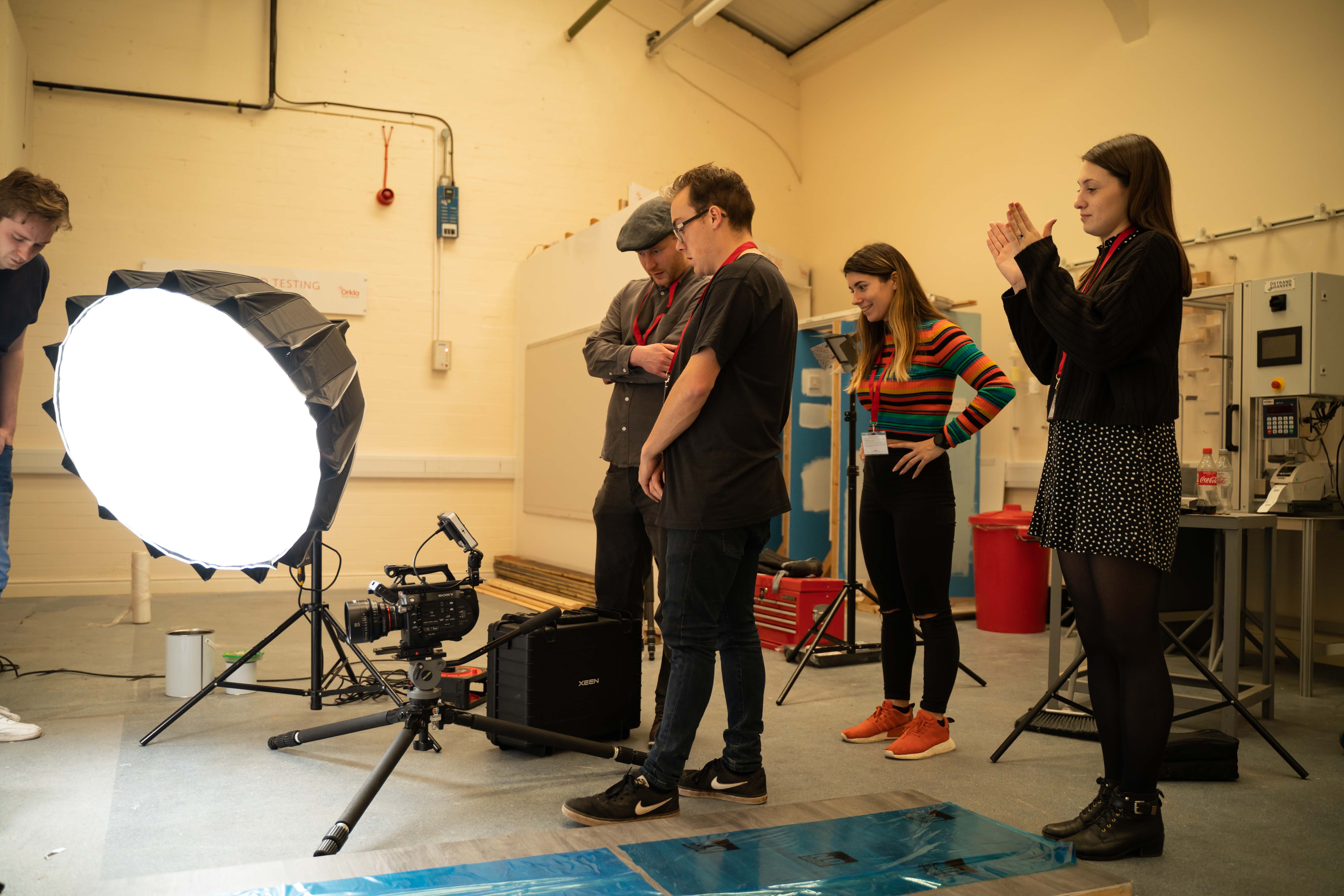 Video production team preparing lighting and camera setup.