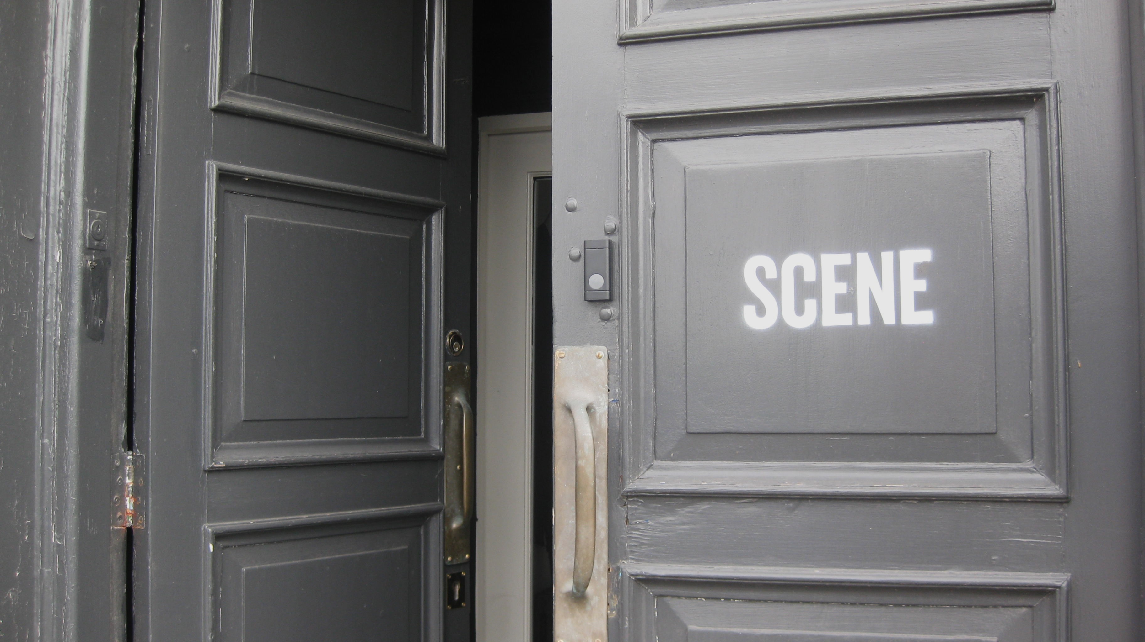Film set door labeled “Scene” at studio entrance.