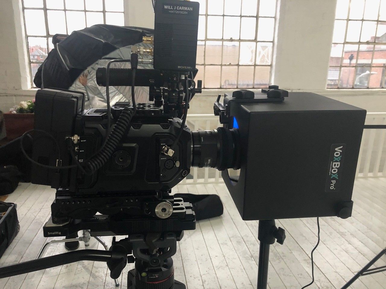 Professional video camera setup with lighting equipment indoors