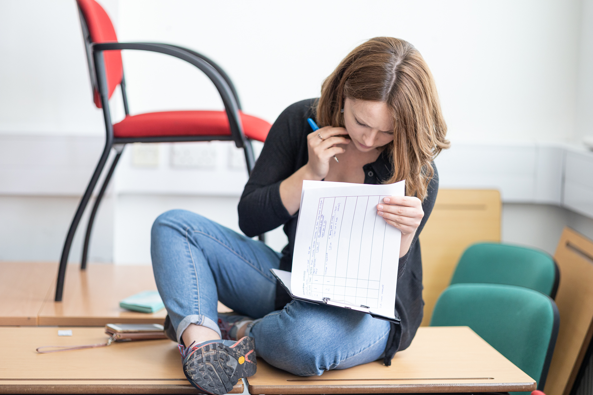 Woman reviewing documents for corporate video production planning