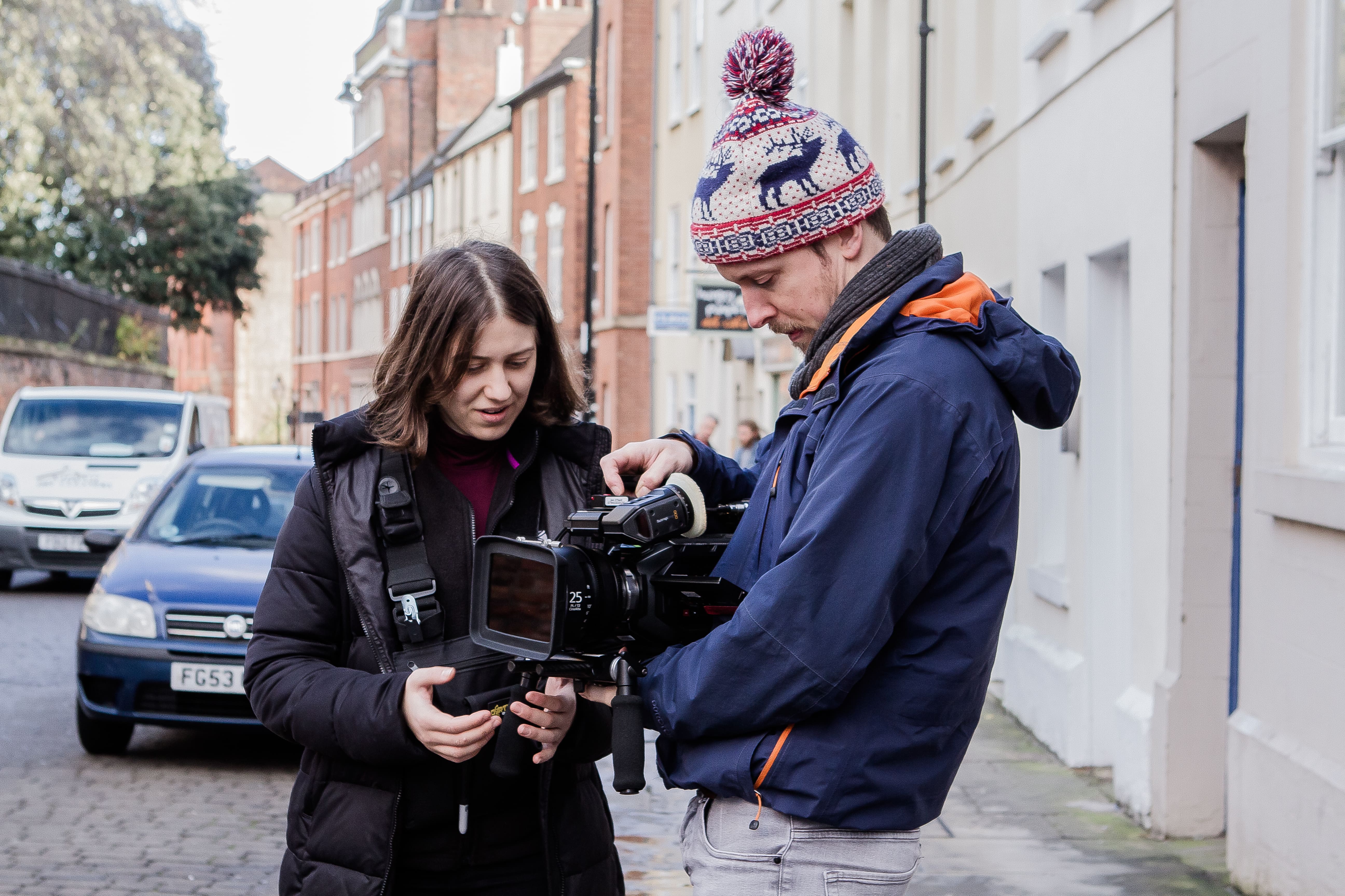 Filmmakers shooting a scene outdoors for a branded content video project.
