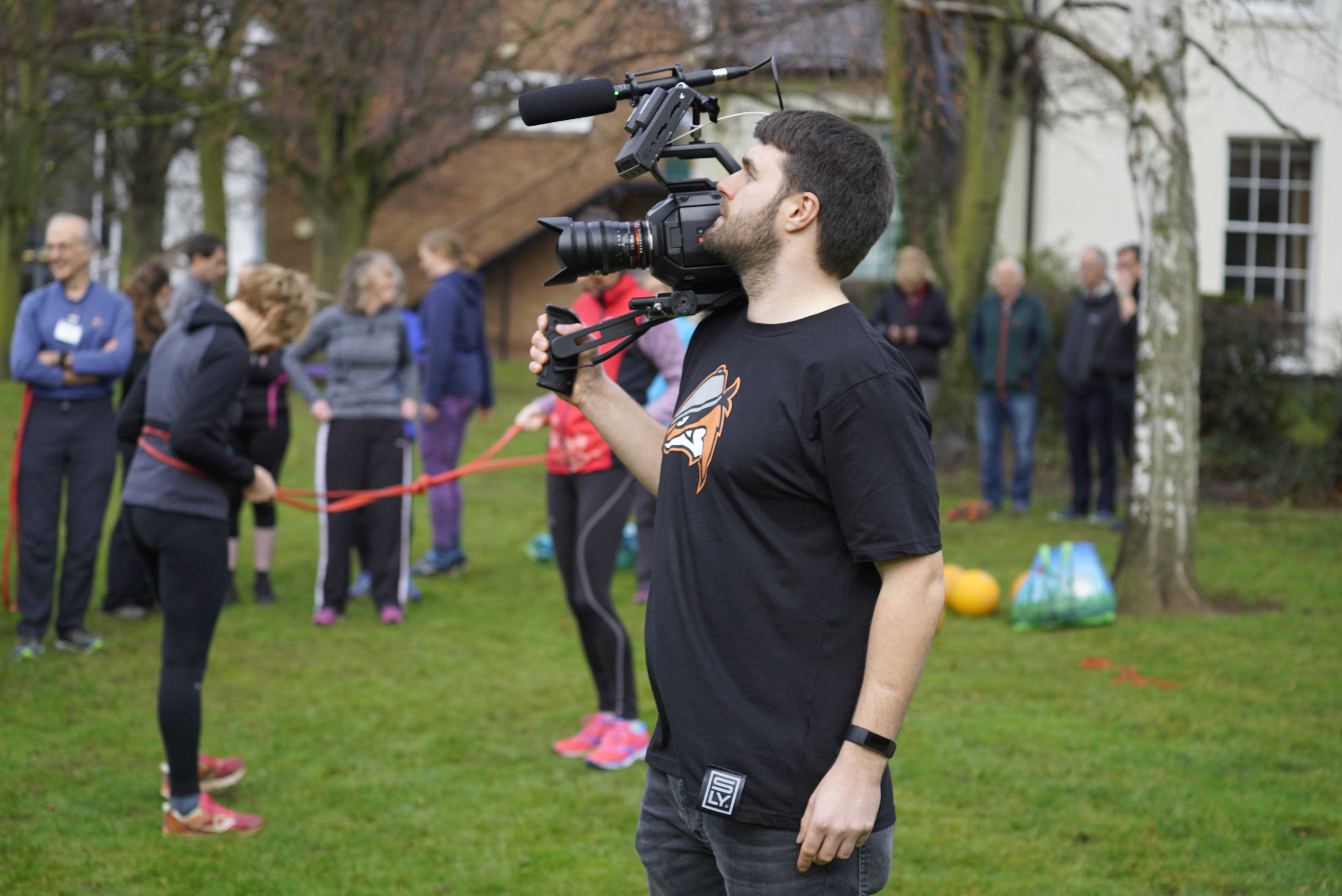 Videographer capturing an outdoor brand event highlighting the benefits of video production for businesses in Derbyshire.