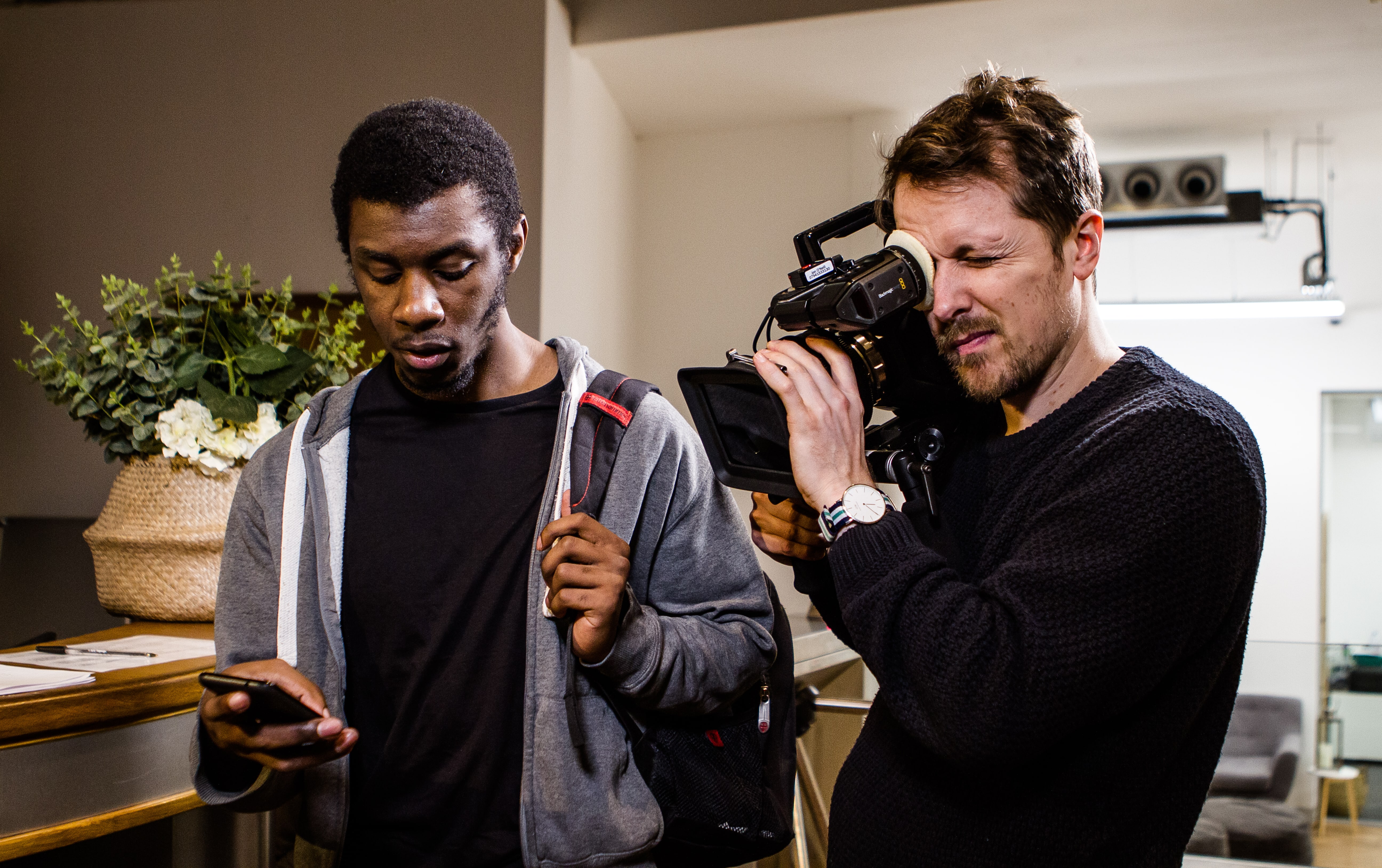 filming a brand video with an actor during a video production shoot.