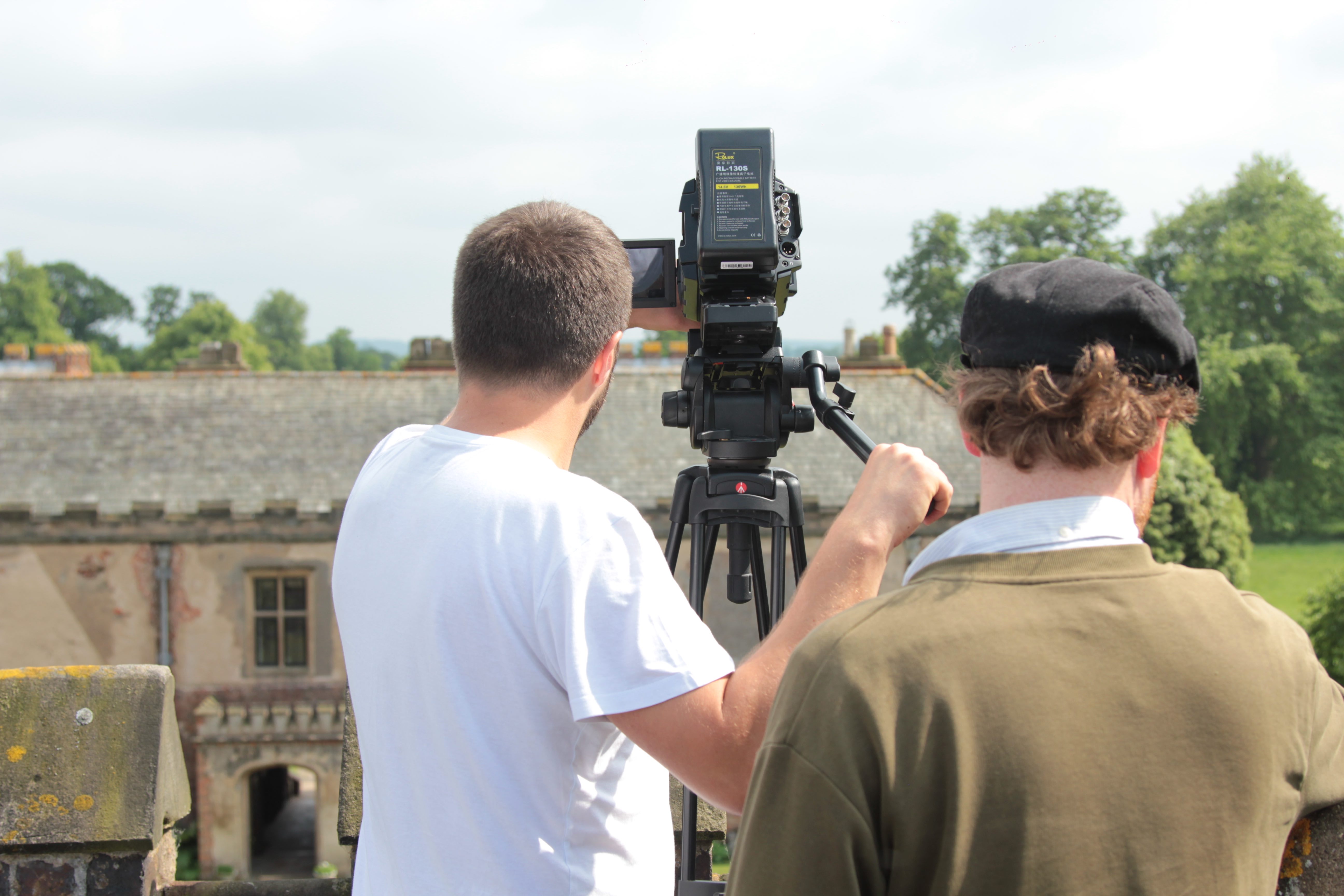 Video crew recording training footage with camera outdoors