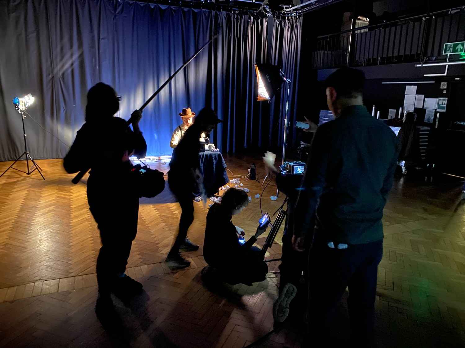 Film crew recording a corporate training video with lighting and camera equipment.