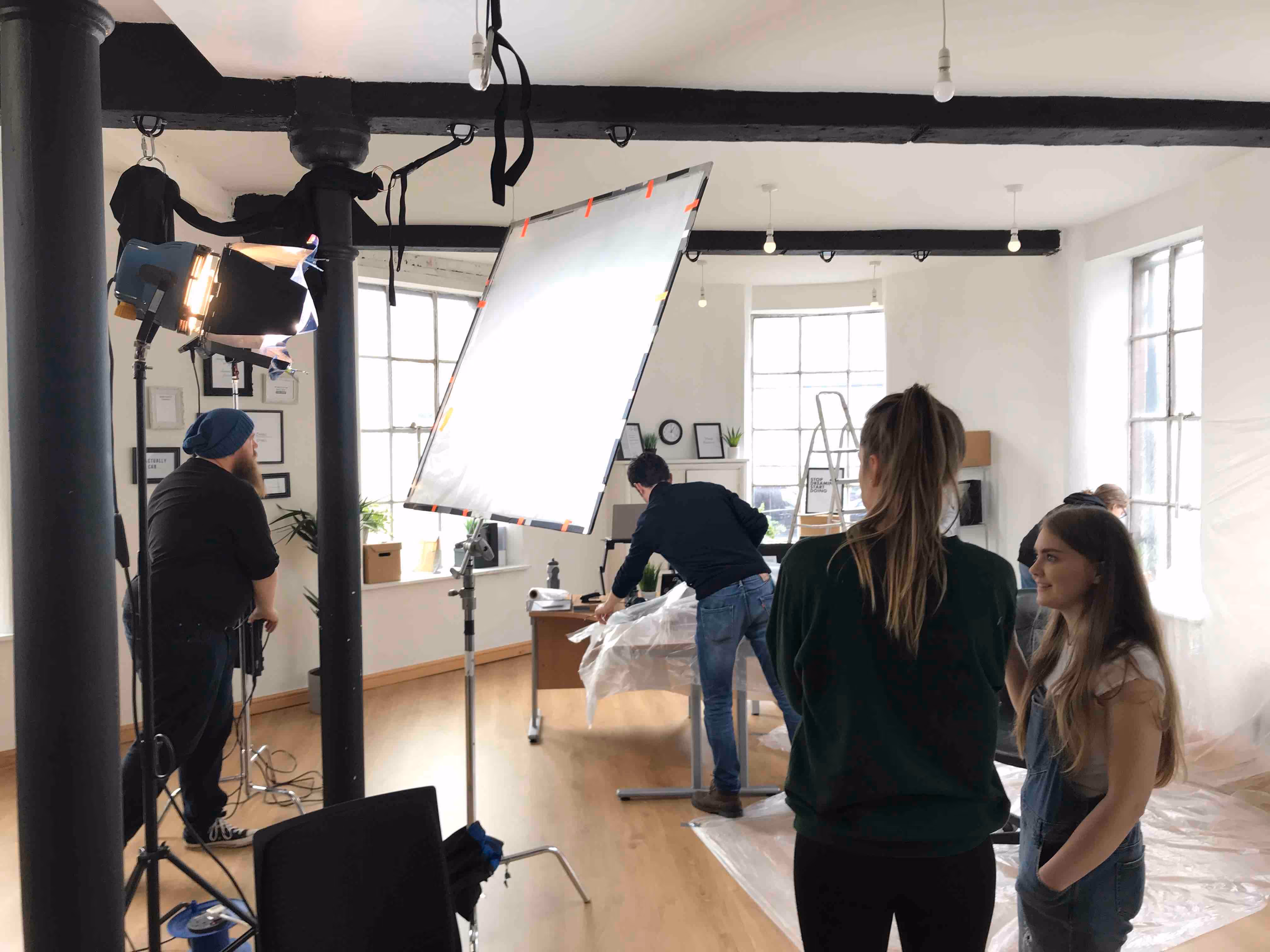 Video retainer production shoot with studio lighting and crew setup
