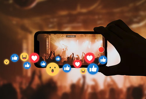 Smartphone recording a live concert with likes and reactions, UGC agency content