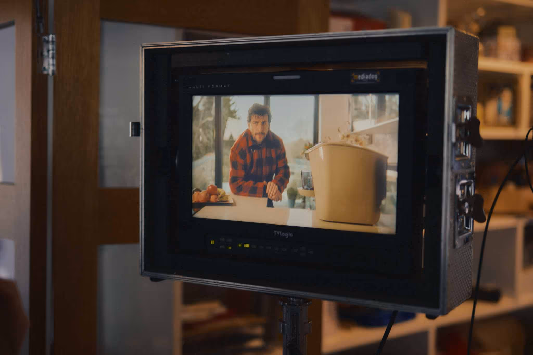Field monitor showing a creator-led corporate video being filmed in a kitchen
