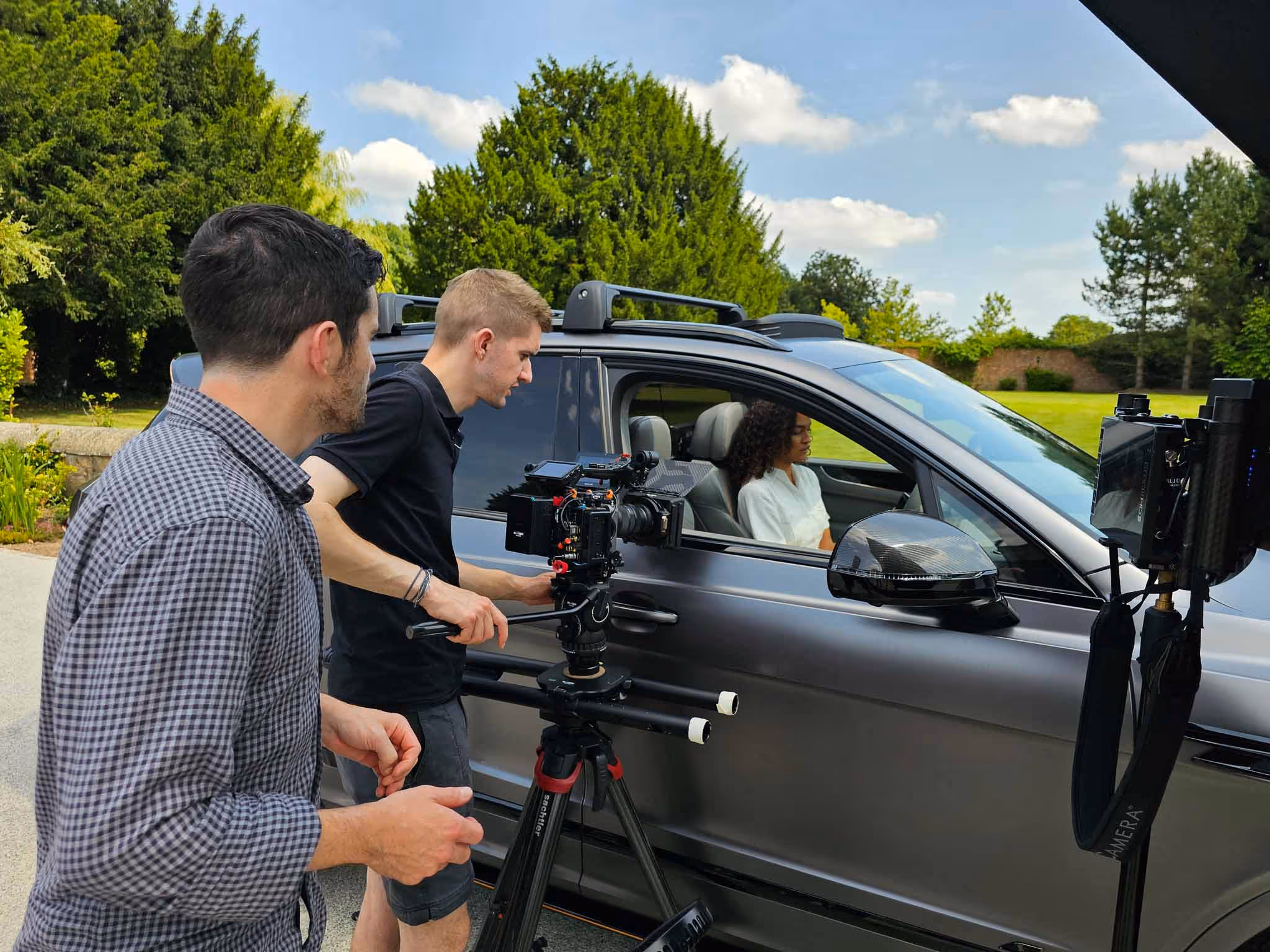Production crew filming a corporate video on location with a single-camera setup