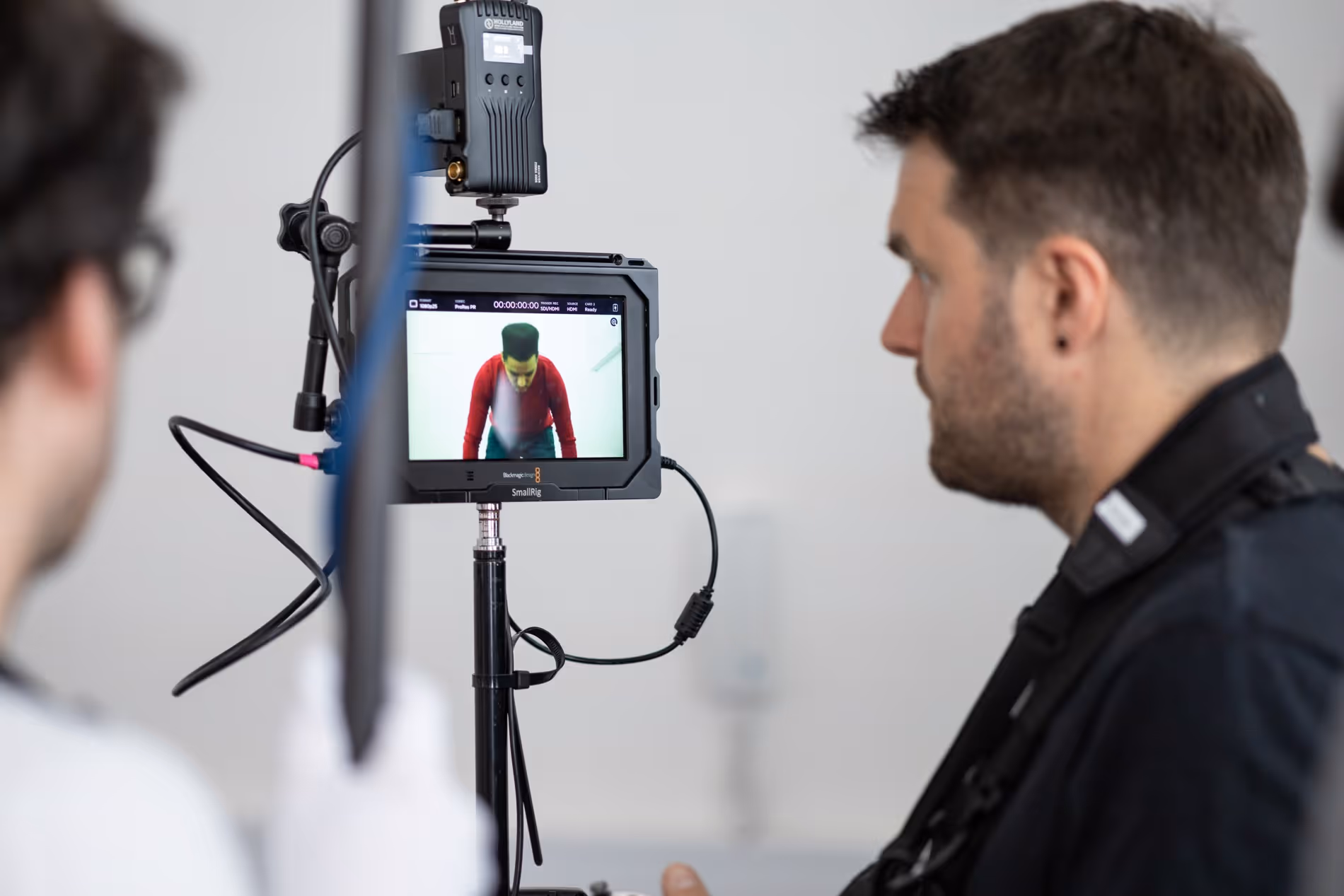 Crew reviewing a shot on a camera monitor during a creator-led corporate video shoot