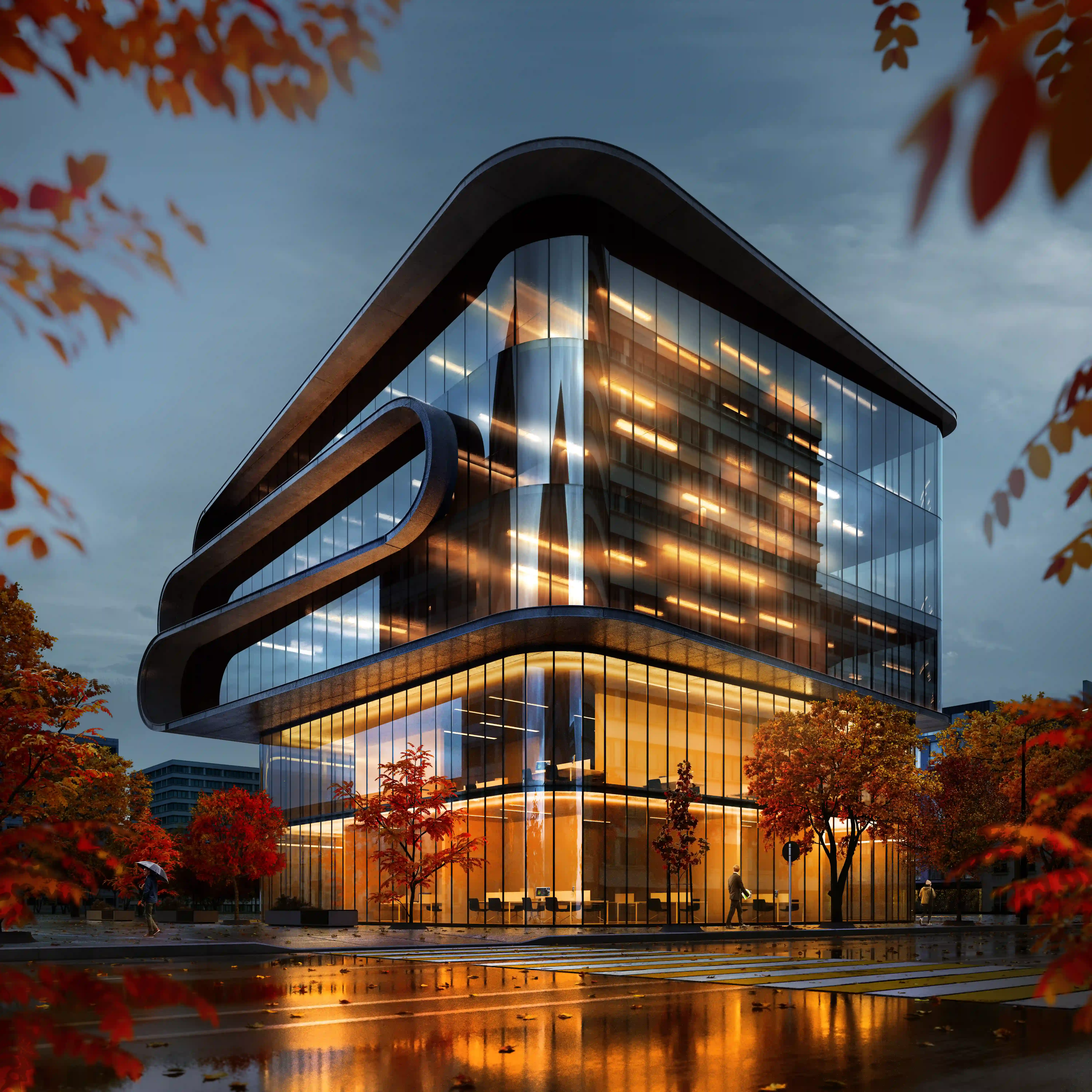 Modern glass office building with rounded edges lit warmly inside, surrounded by autumn trees and wet street reflections at dusk.