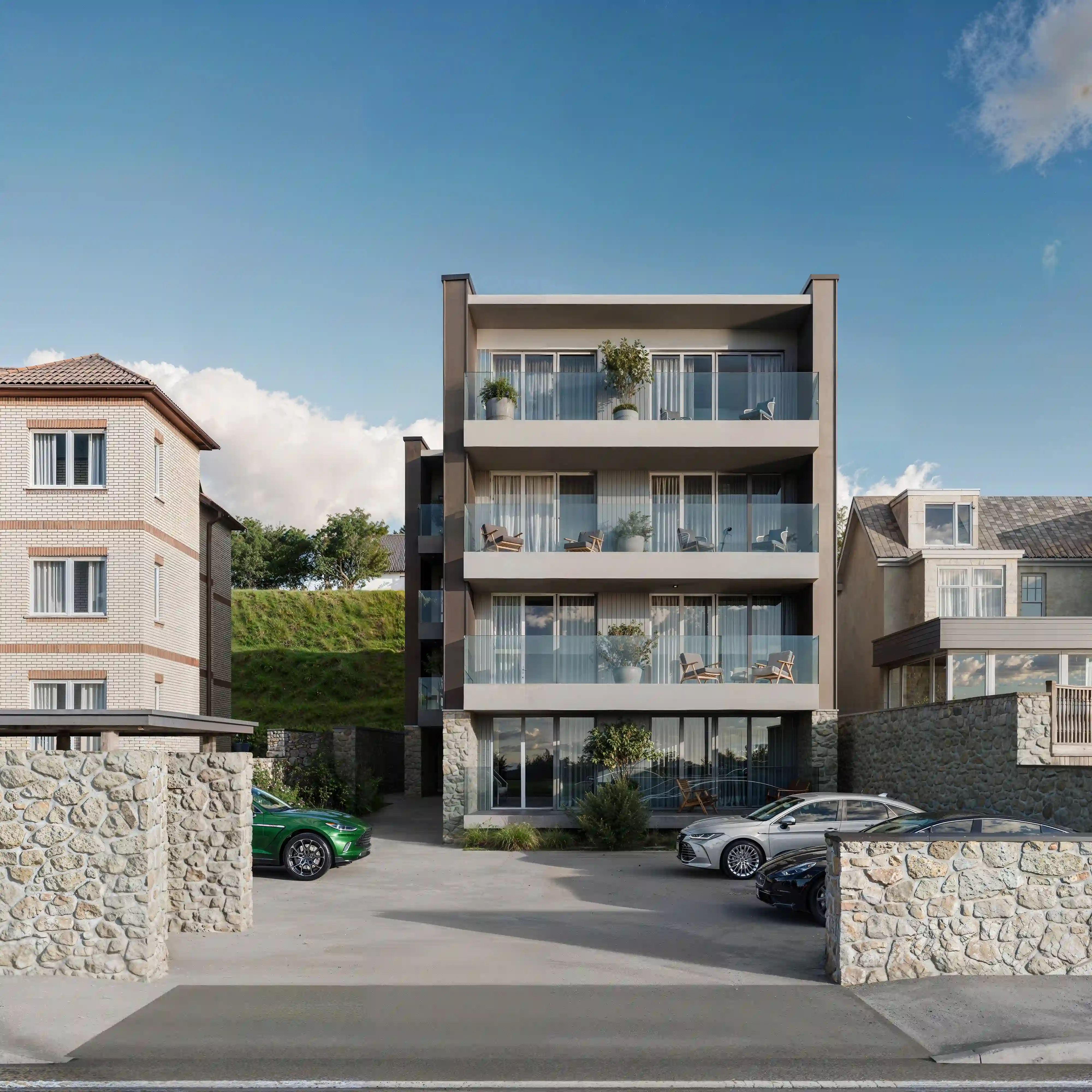 Modern four-story apartment building with balconies, outdoor chairs, potted plants, and a parking area with cars in front under a partly cloudy sky.
