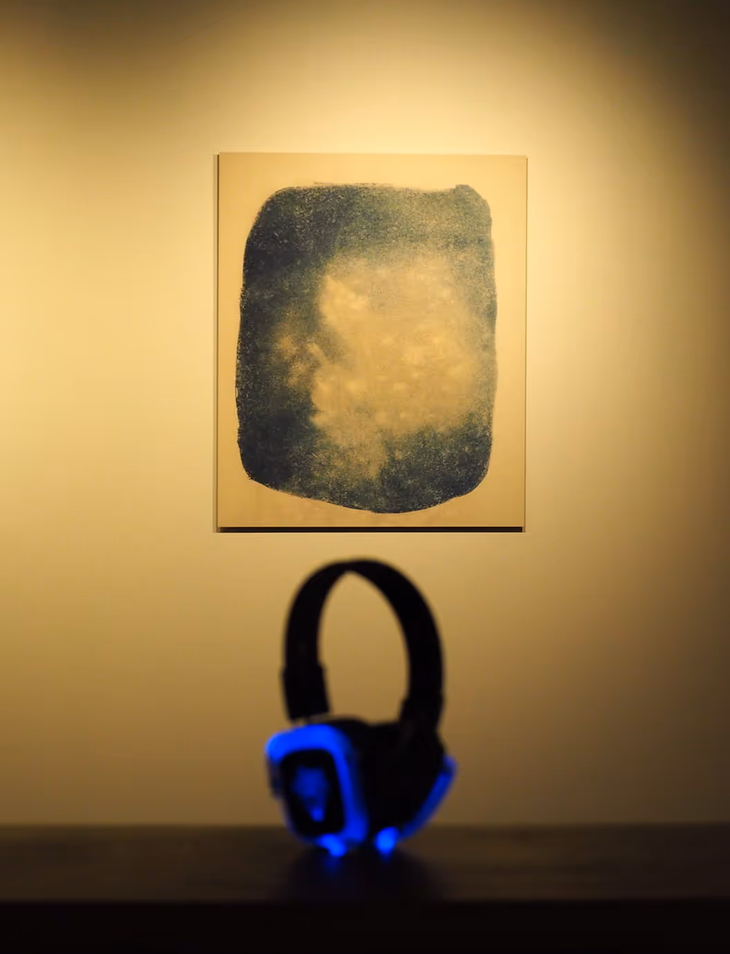 Premier plan d'un casque en fâce d'un tableau abstrait