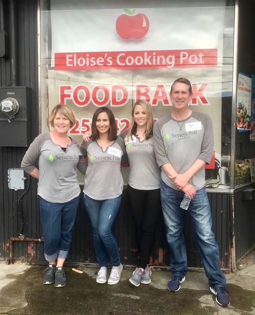 A group of people standing in front of a food truck.