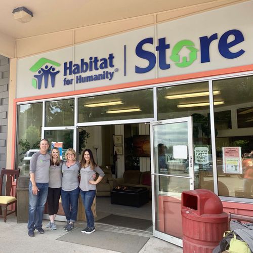 A group of people standing in front of a store.