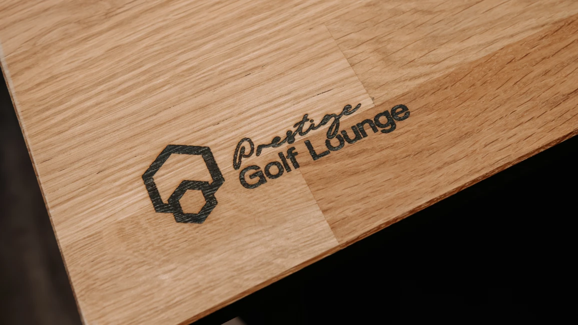 Prestige Golf Lounge logo engraved into a wood countertop