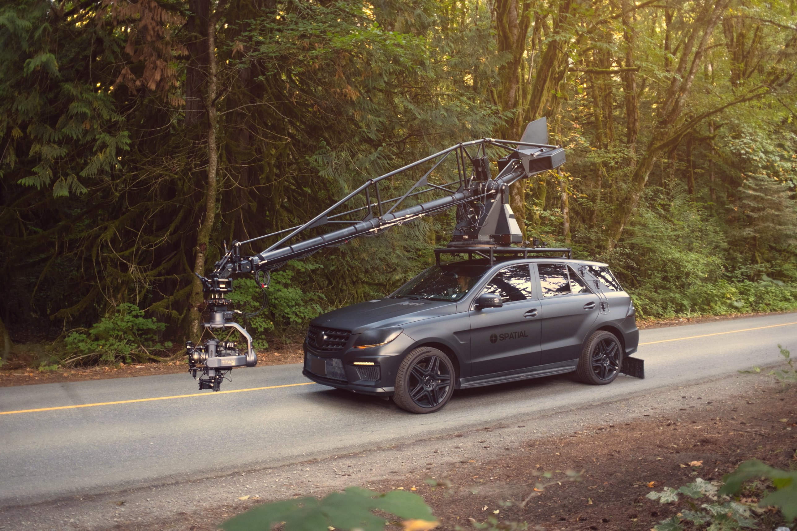 Spatial arm car with a Motocrane crane arm and Titan gimbal on a forest road