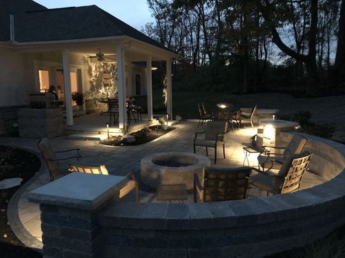 patio at night with lights and fire pit