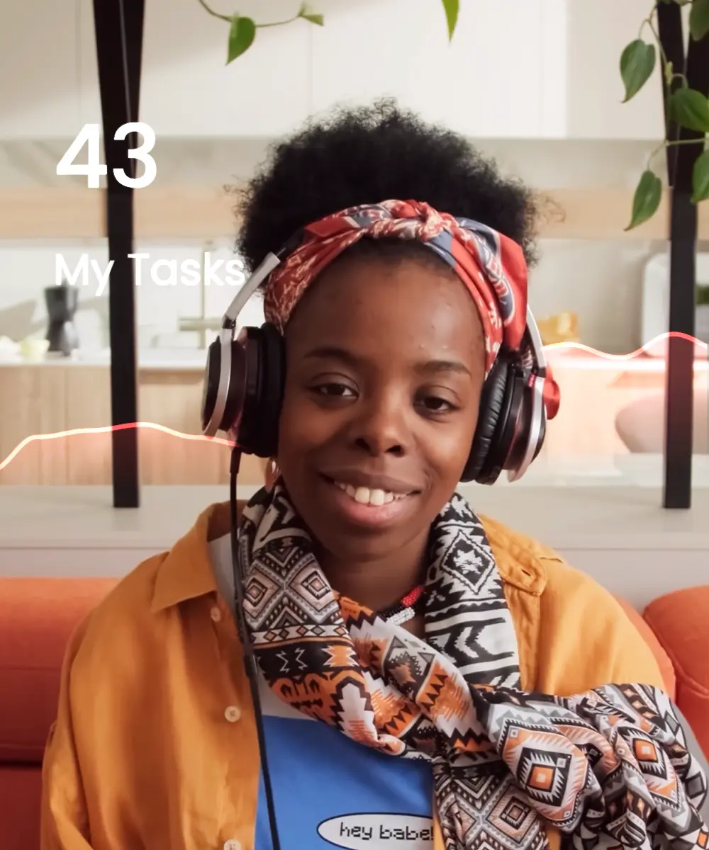 A girl in an orange jacket sitting in the earpads and listening to music.