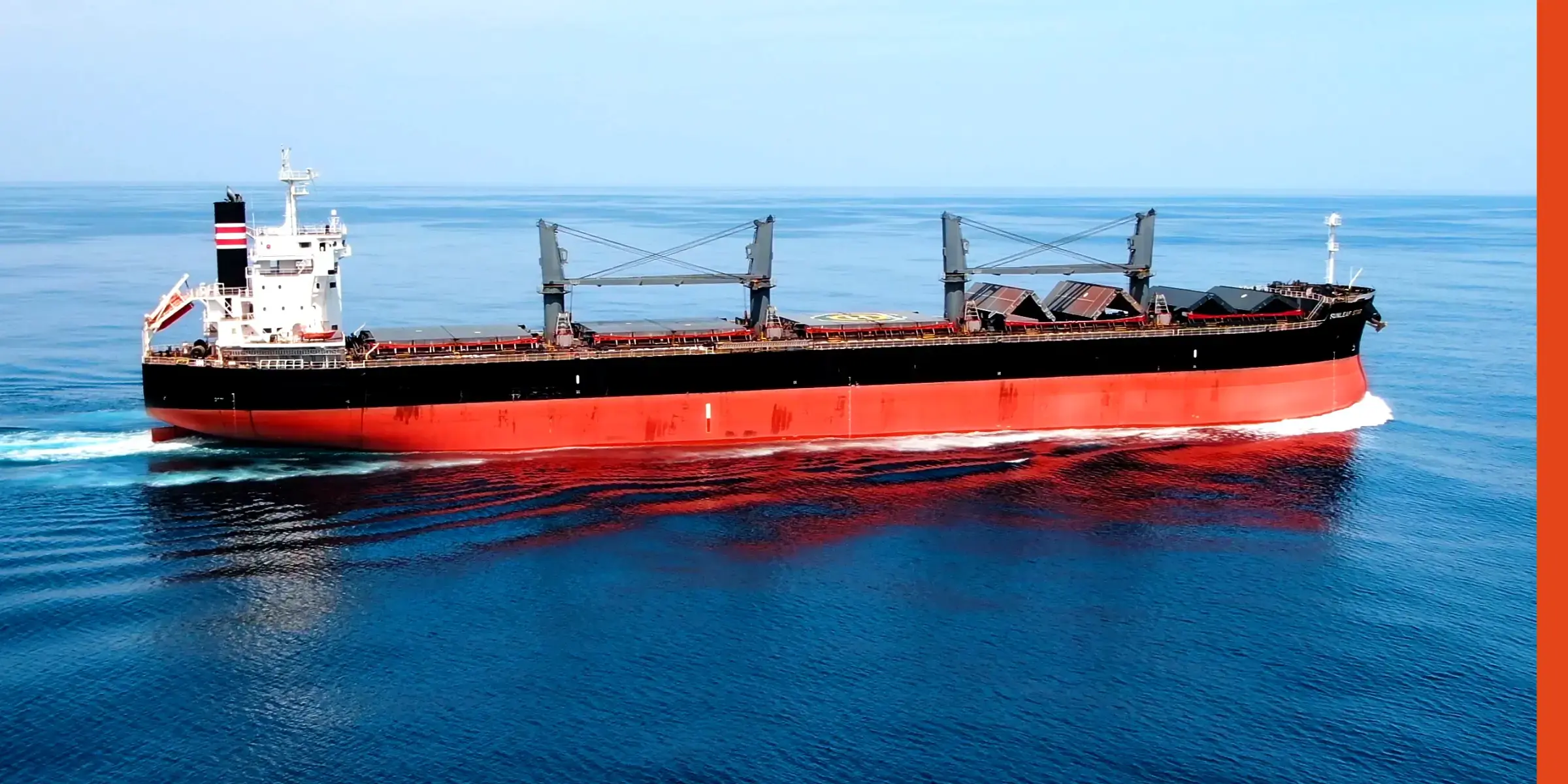 A vessel full of cargo traveling by sea.