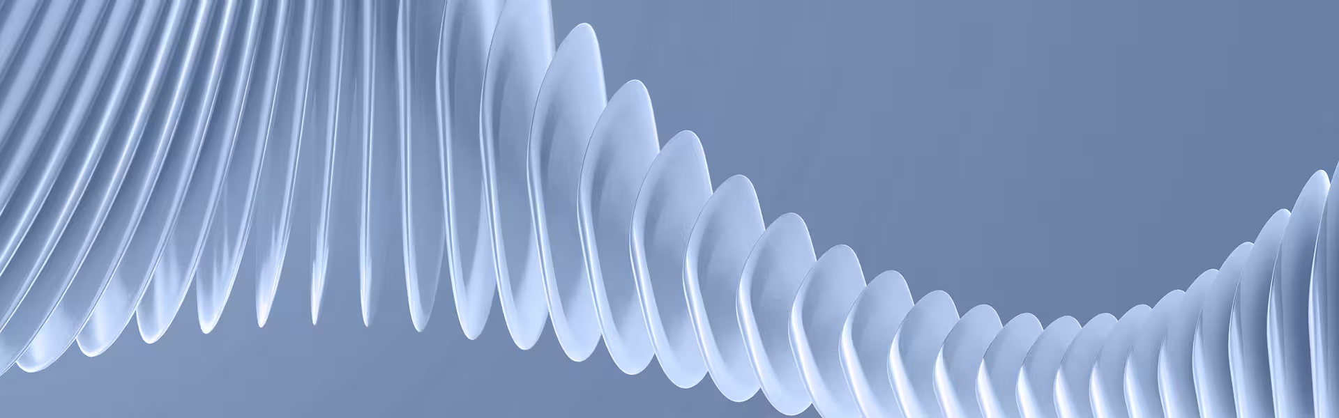 Abstract close-up of a series of smooth, translucent, curved shapes arranged in a flowing, wave-like pattern against a soft blue background.
