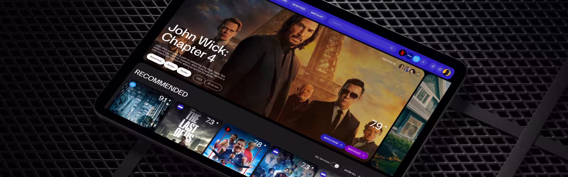 Tablet screen displaying modern streaming platform UI with John Wick: Chapter 4 featured and recommended movies section