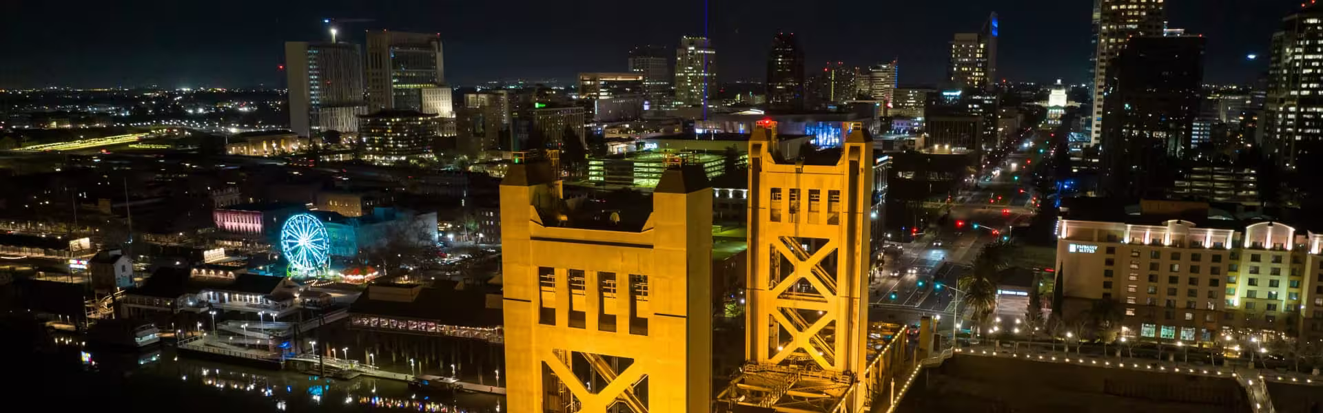 Night view of Sacramento city skyline with illuminated Tower Bridge — header image for Lazarev.agency’s Sacramento web design services page