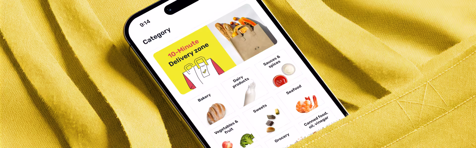 Close-up of grocery delivery app interface on smartphone showing 10-minute delivery zone and product categories — bright yellow background design by Lazarev.agency for Ninja app