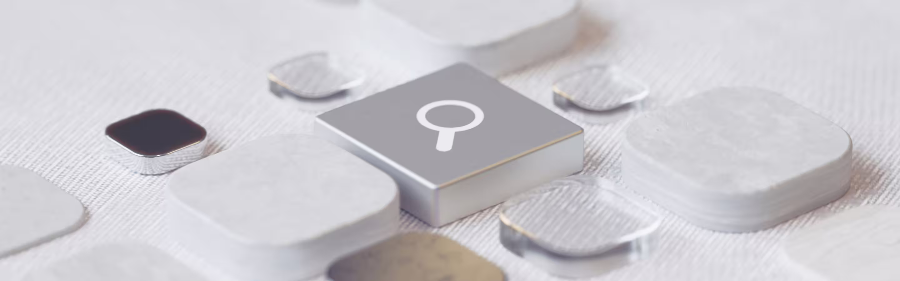 Close-up of a gray search icon key on a keyboard surrounded by rounded, translucent keys on a textured surface.