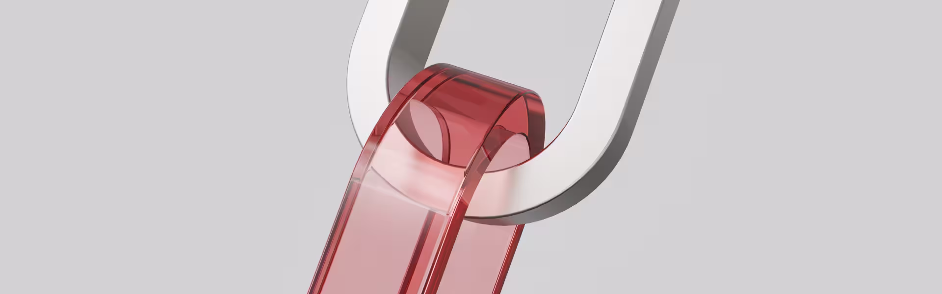 Close-up 3D render of a red translucent link connected to a polished metallic U-shaped component