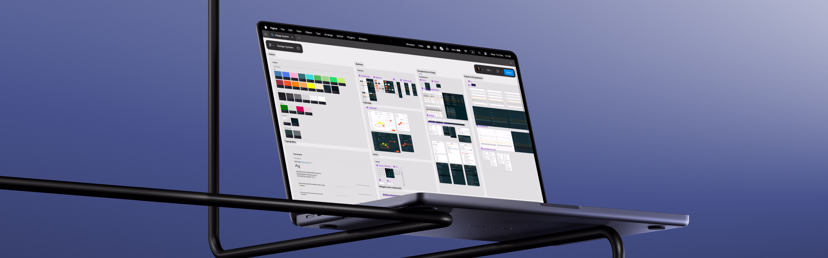 A sleek laptop screen displays a design software interface showcasing color palettes, buttons, and various UI components.