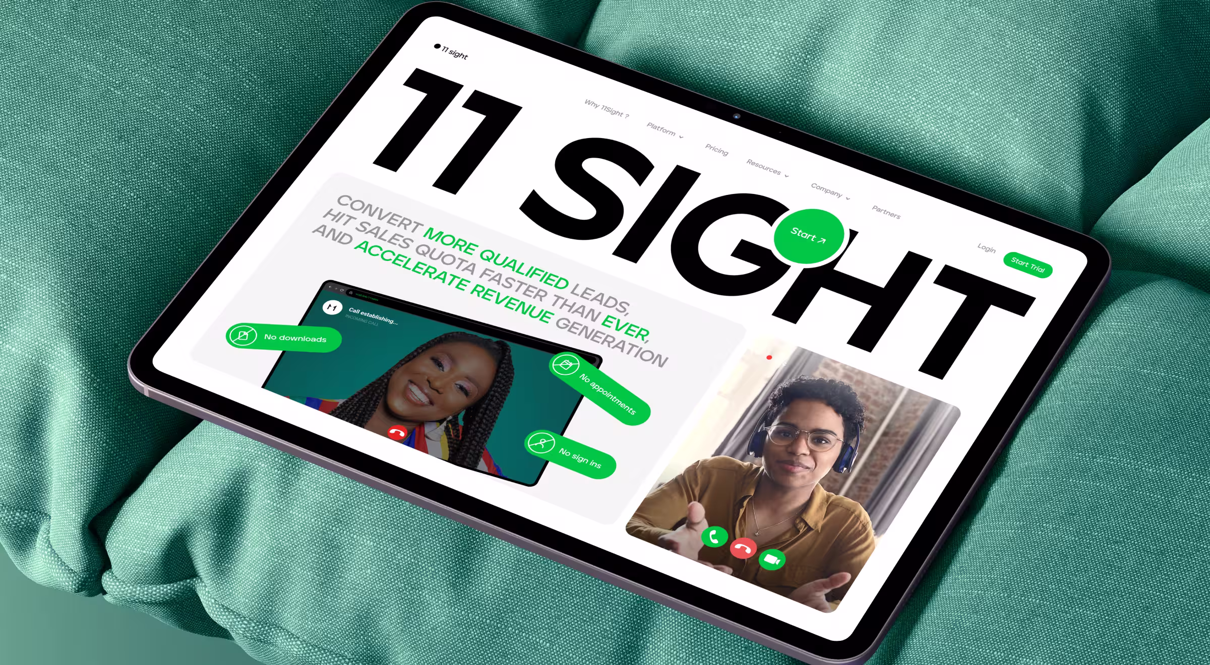 Tablet resting on green fabric displaying the 11Sight website, featuring a bold “11 SIGHT” headline, green call-to-action buttons, and video call interfaces highlighting sales conversations and revenue acceleration