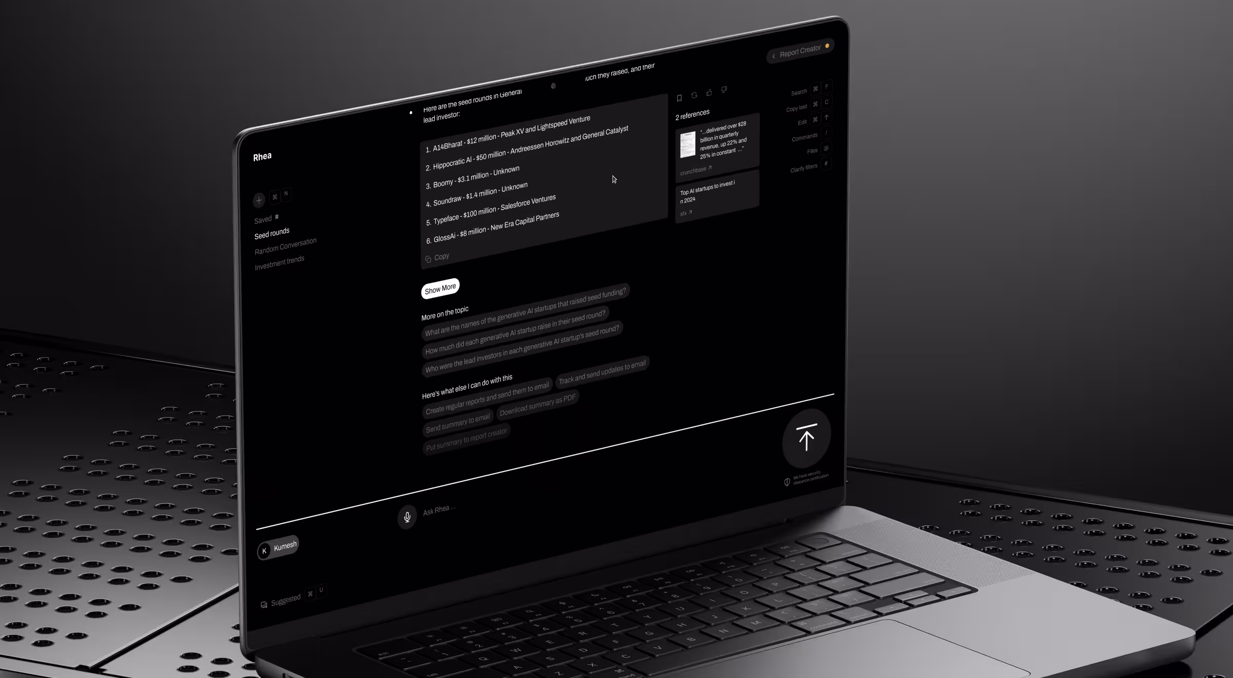 Dark-mode AI assistant interface displayed on a laptop in a server-like environment, showing a list of startup seed rounds, references panel, suggested follow-up questions, and a chat input field labeled “Ask Rhea.”