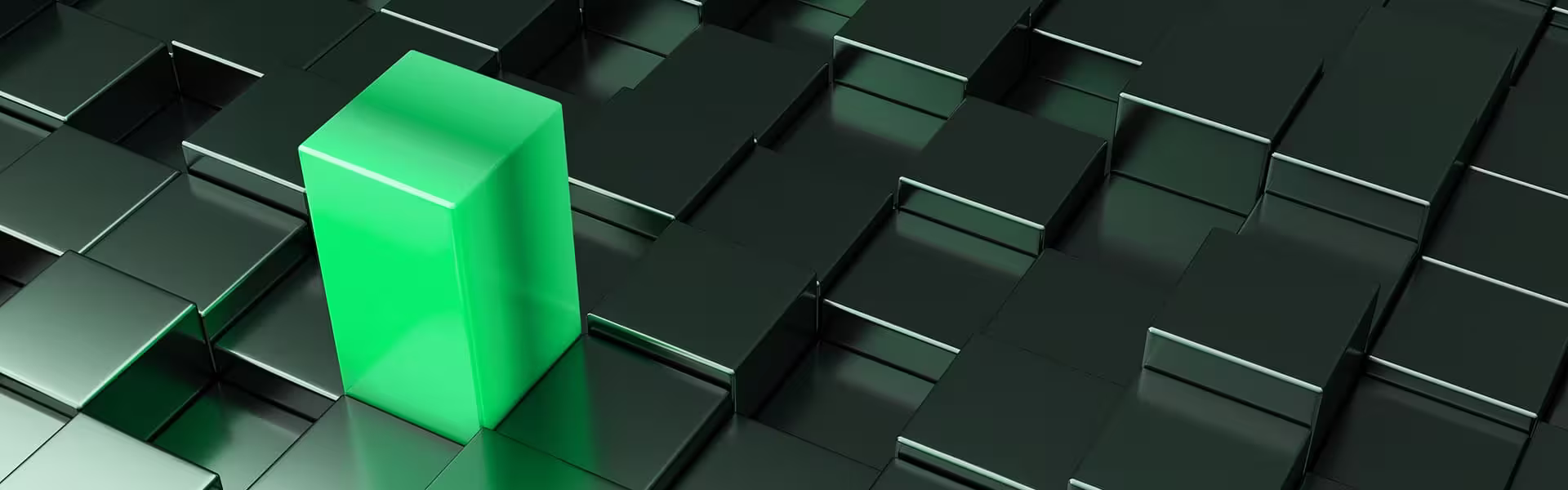 Glowing green cube standing out among a grid of dark metallic blocks, symbolizing differentiation or standout performance