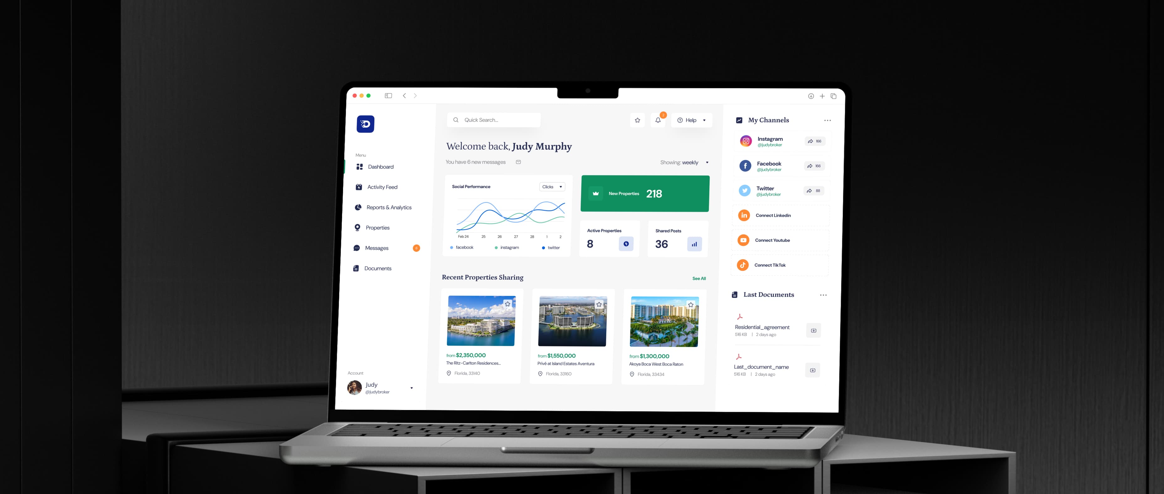 Laptop displaying a real estate SaaS dashboard with property listings, social media performance metrics, document management, and activity tracking, designed to help agents monitor marketing efforts and manage property portfolios.