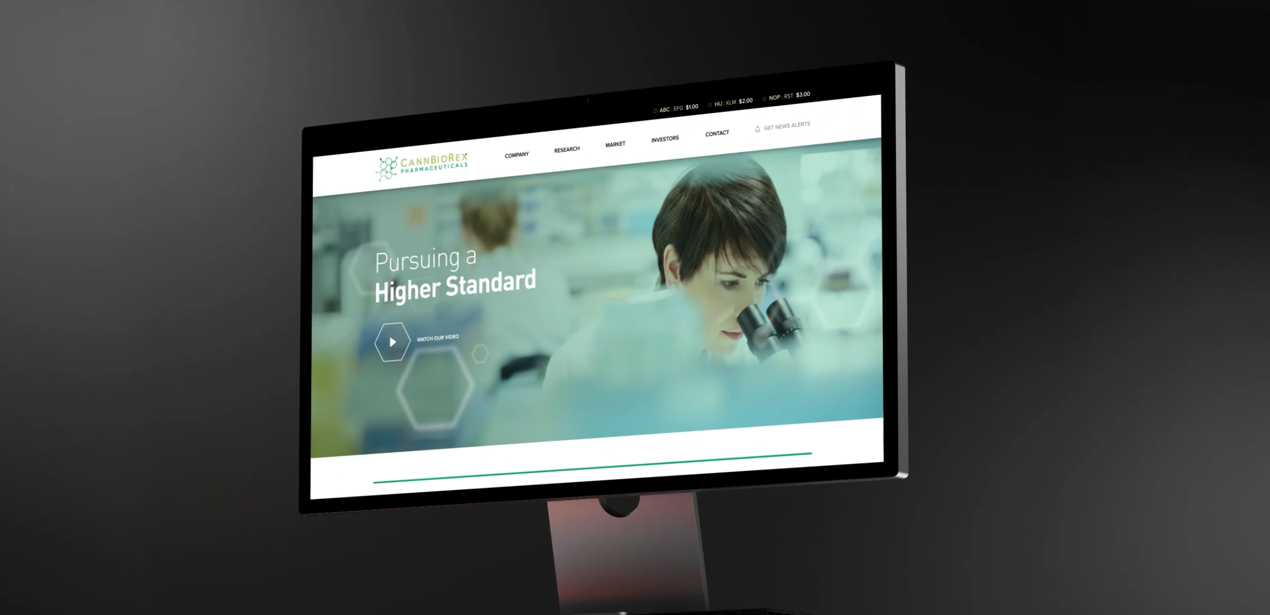 CannBioRex Pharmaceuticals website displayed on a desktop monitor, featuring a laboratory researcher using a microscope and the headline “Pursuing a Higher Standard.”