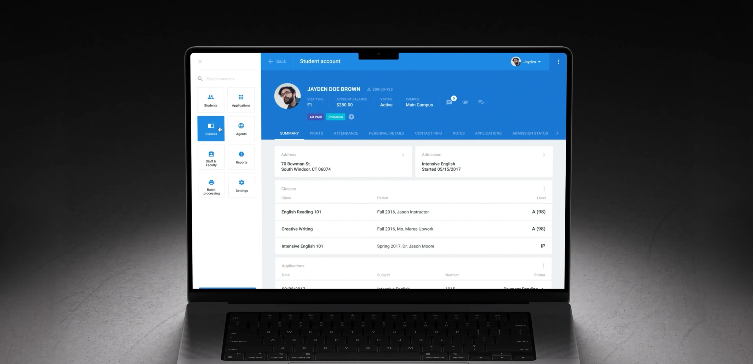 Campus AXESS student account summary open on a laptop, with visa type, account balance, status, and campus pinned in a header above the student's address, admission, class grades, and applications.