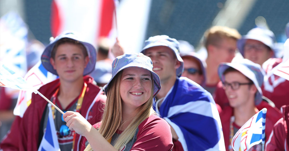 Young athletes waving Newfoundland and Labrador flags at the Canada Games. 