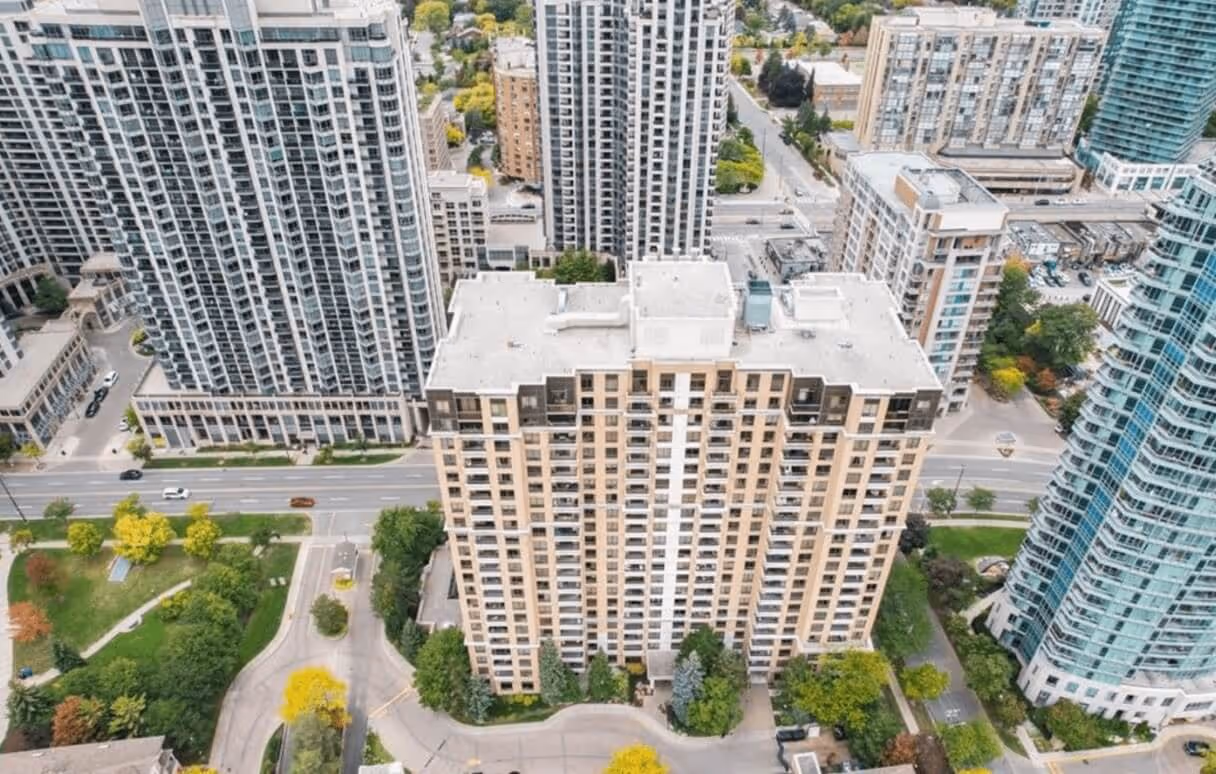 Aerial view of a cluster of modern high-rise residential buildings surrounded by streets and greenery.
