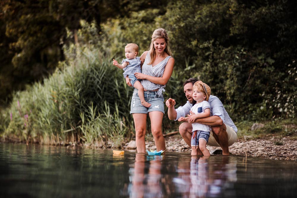 Young family with two children spending time by the water, symbolizing quality family time and ADHD-friendly scheduling strategies.