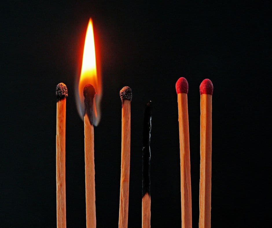 Brennende Streichhölzer, von denen nur eines noch brennt – Symbolbild für Burnout, emotionale Erschöpfung, Überlastung und die Hoffnung auf Regeneration.